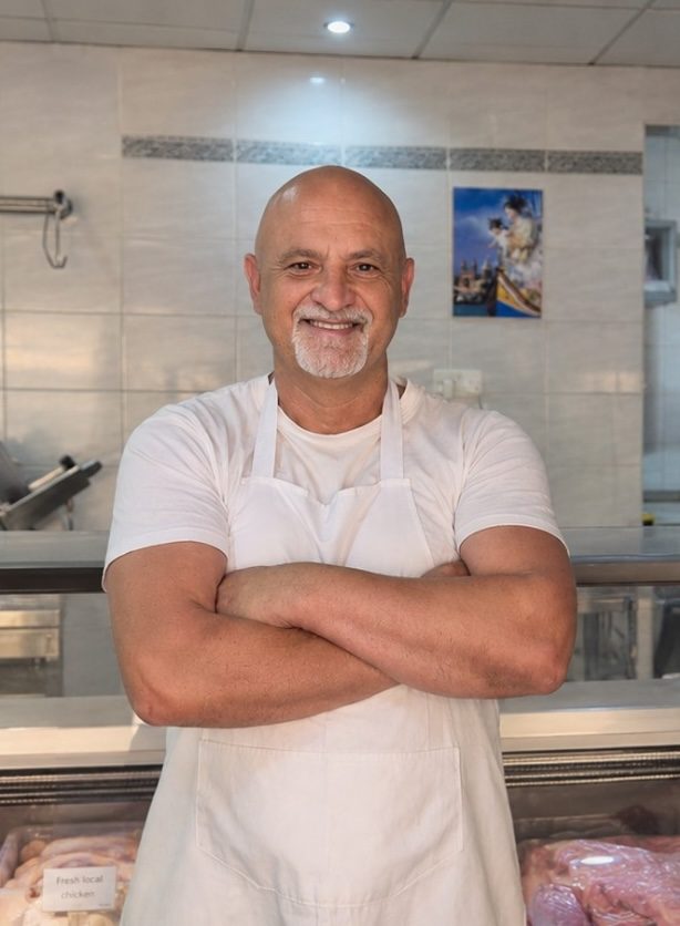 The butcher behind the counter at CS Butcher in Marsaxlokk